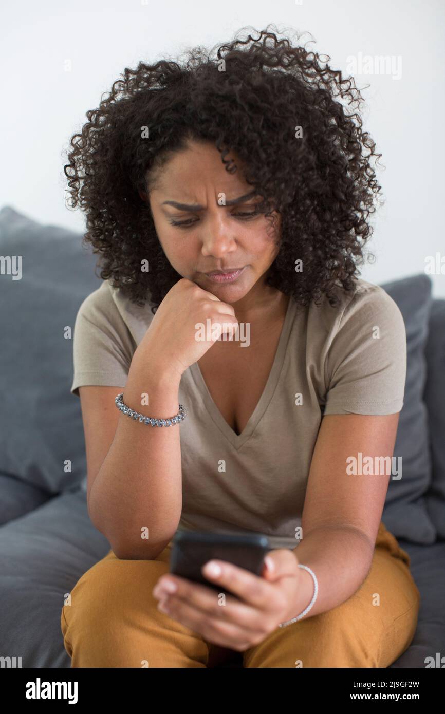 Woman reading message on smart phone Stock Photo