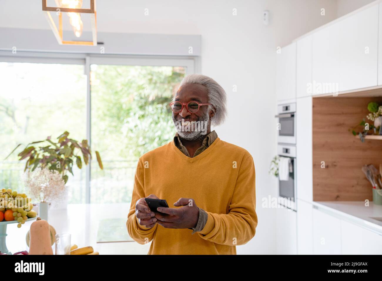 Senior man holding smart phone Stock Photo