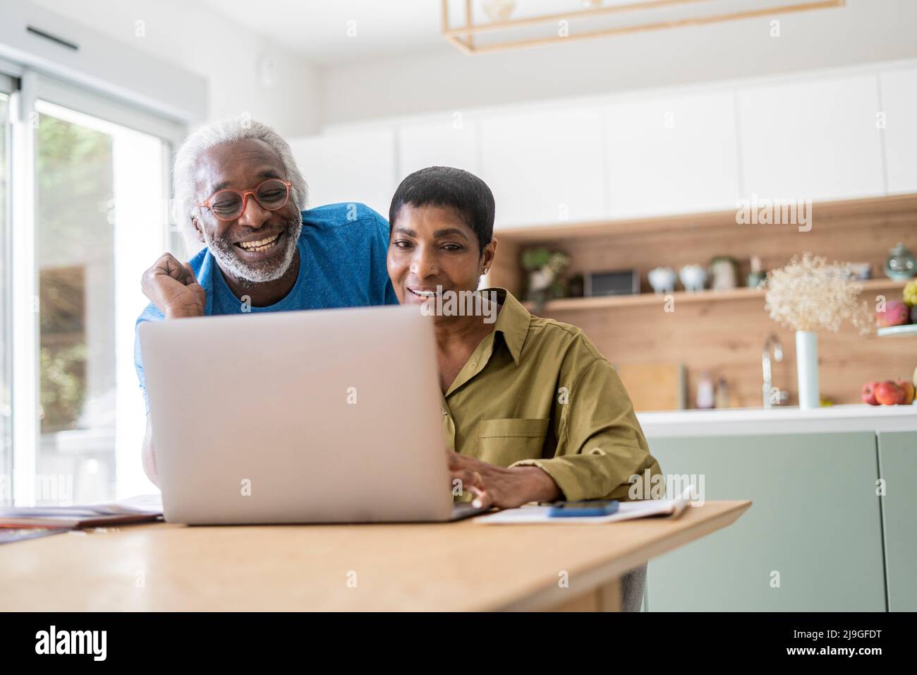 Couple checking documents in kitchen Stock Photo