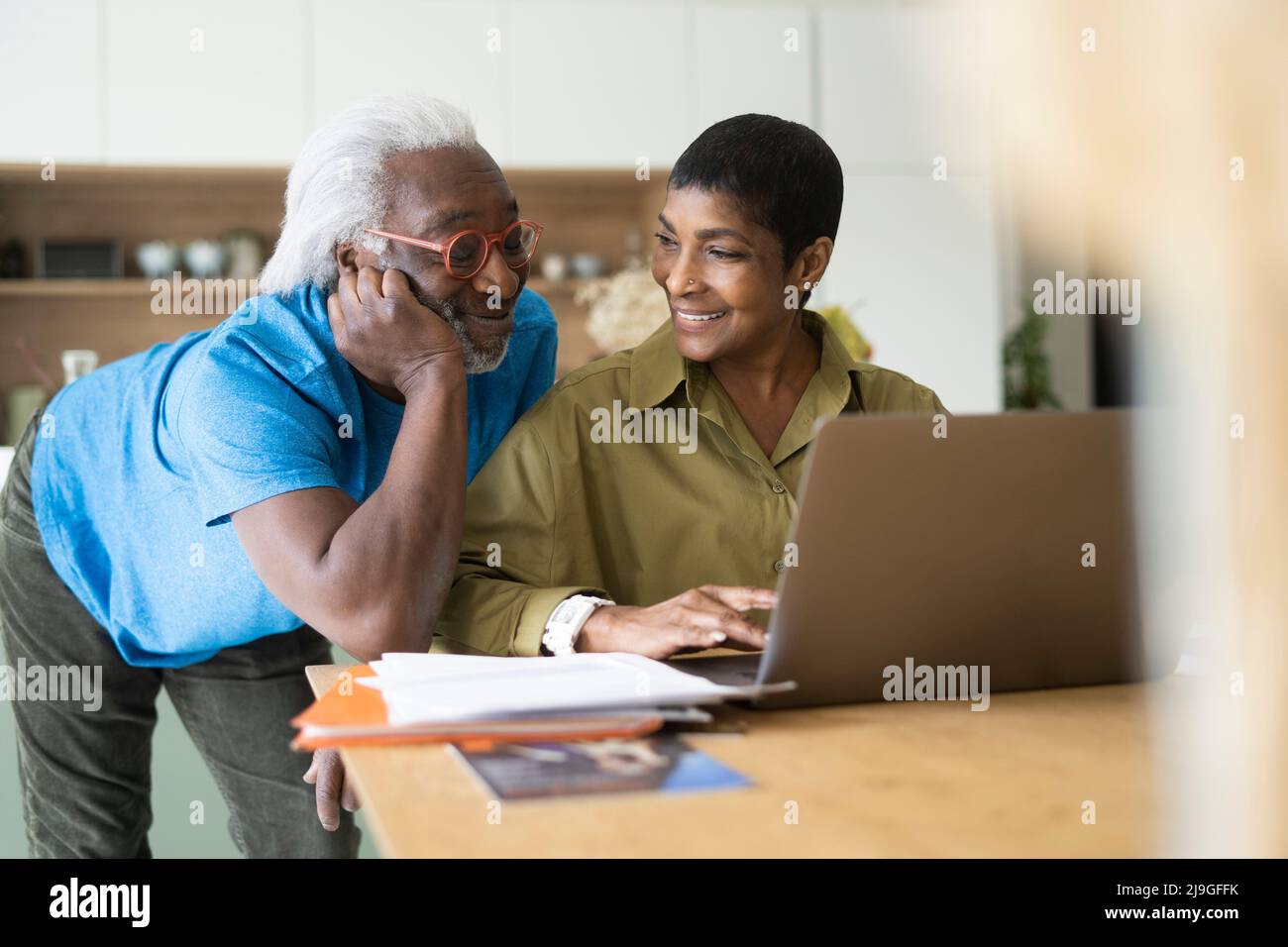 Couple checking documents in kitchen Stock Photo