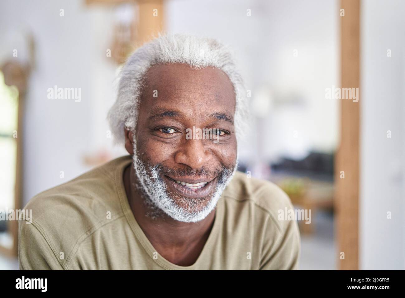 Smiling senior man in kitchen Stock Photo