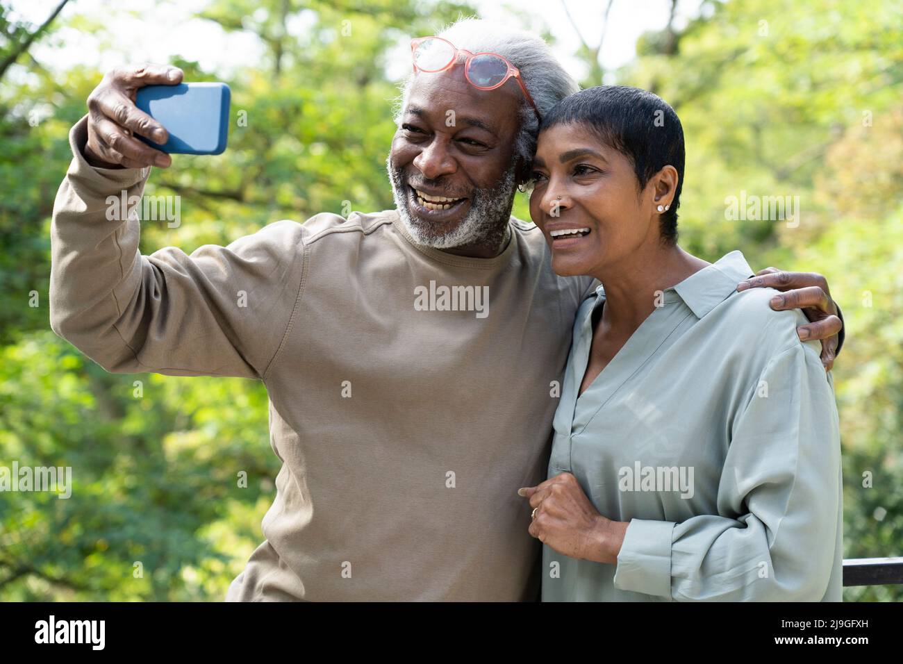 Smiling couple taking selfie with smart phone Stock Photo