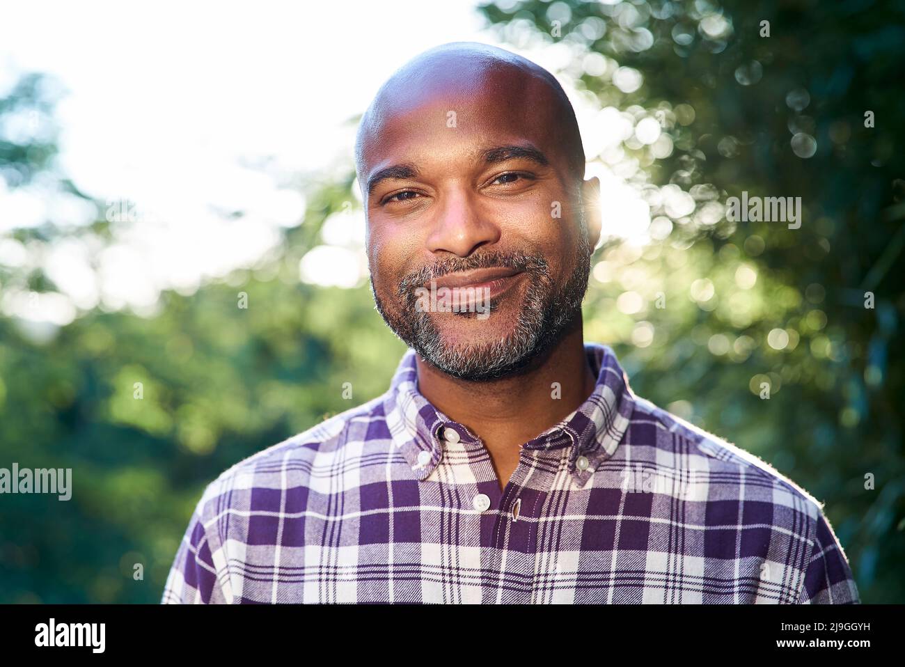 Close-up of a smiling man standing in garden Stock Photo