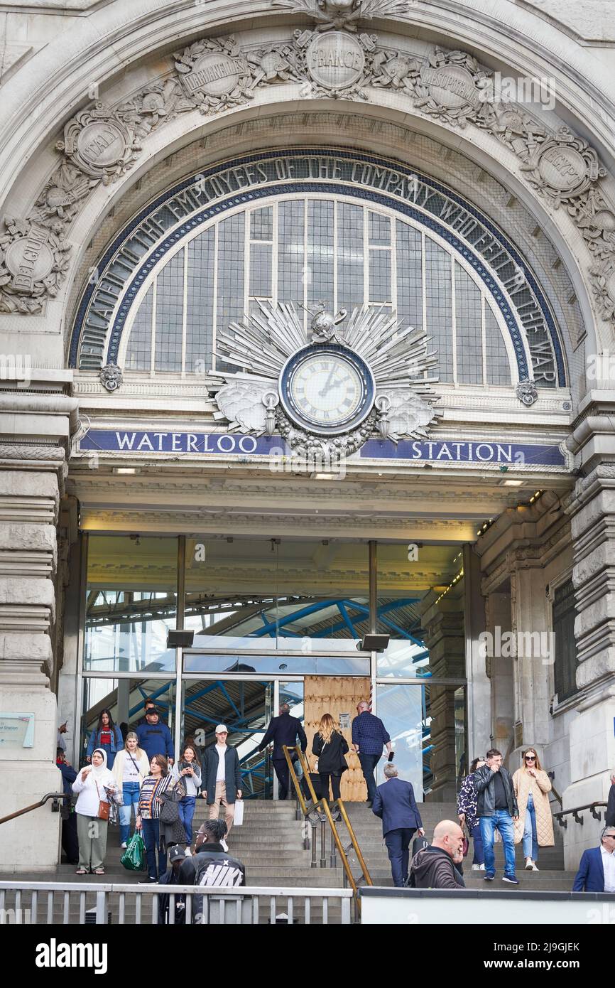 Travellers at the entrance and exit of Waterloo railway station, London