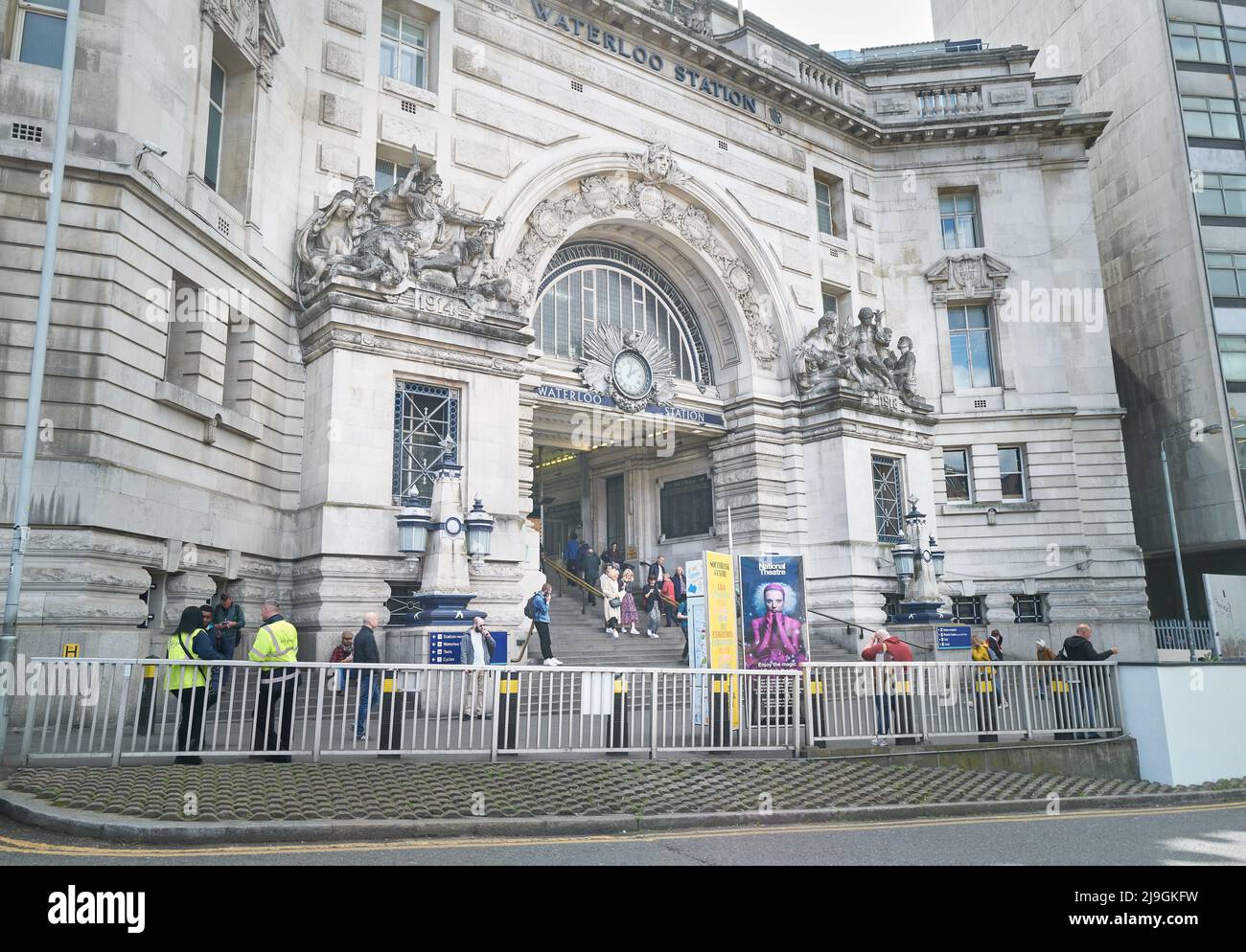 Travellers at the entrance and exit of Waterloo railway station, London