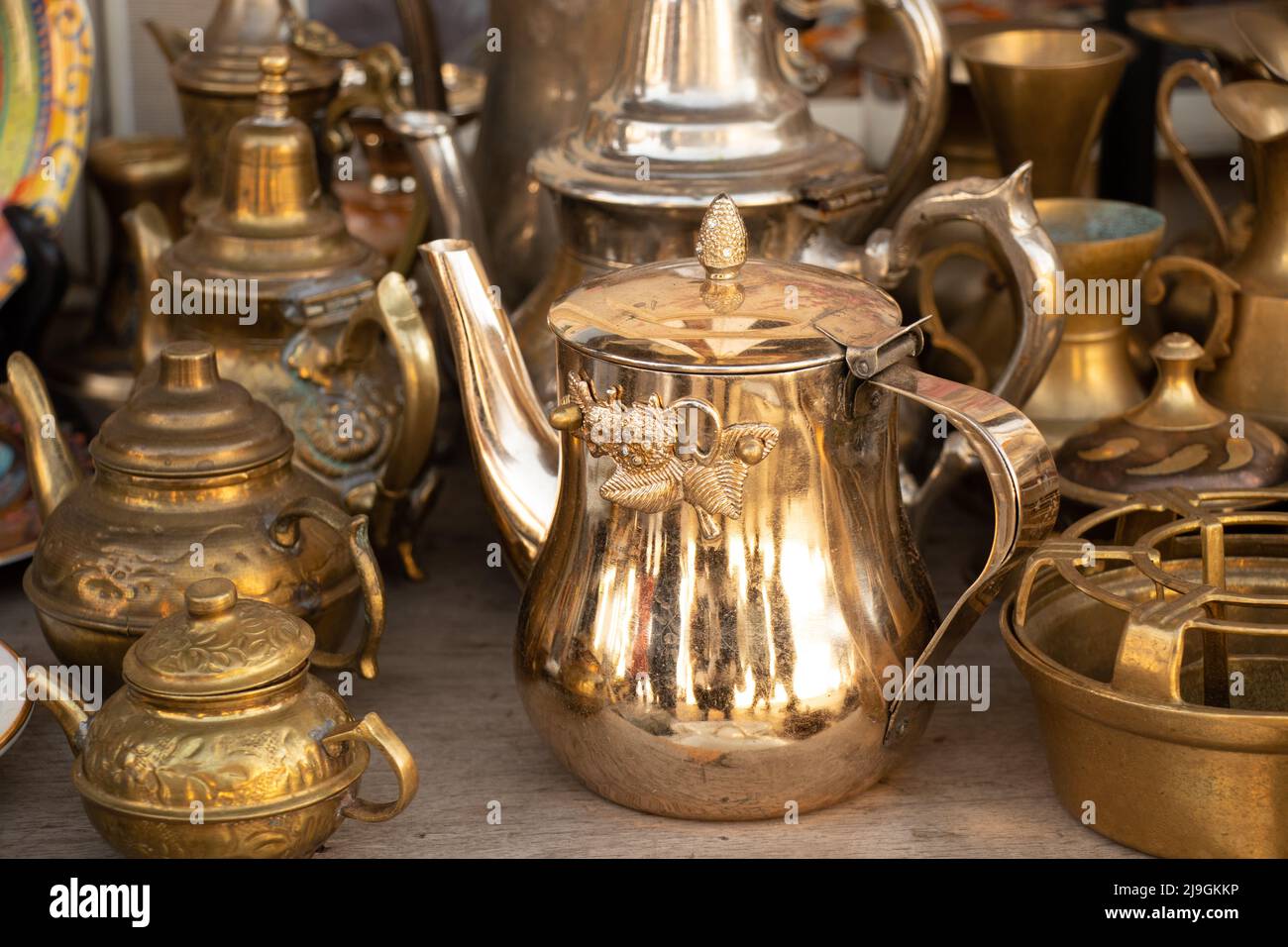 Copper antique jugs on the shelves, a collection of antique copper