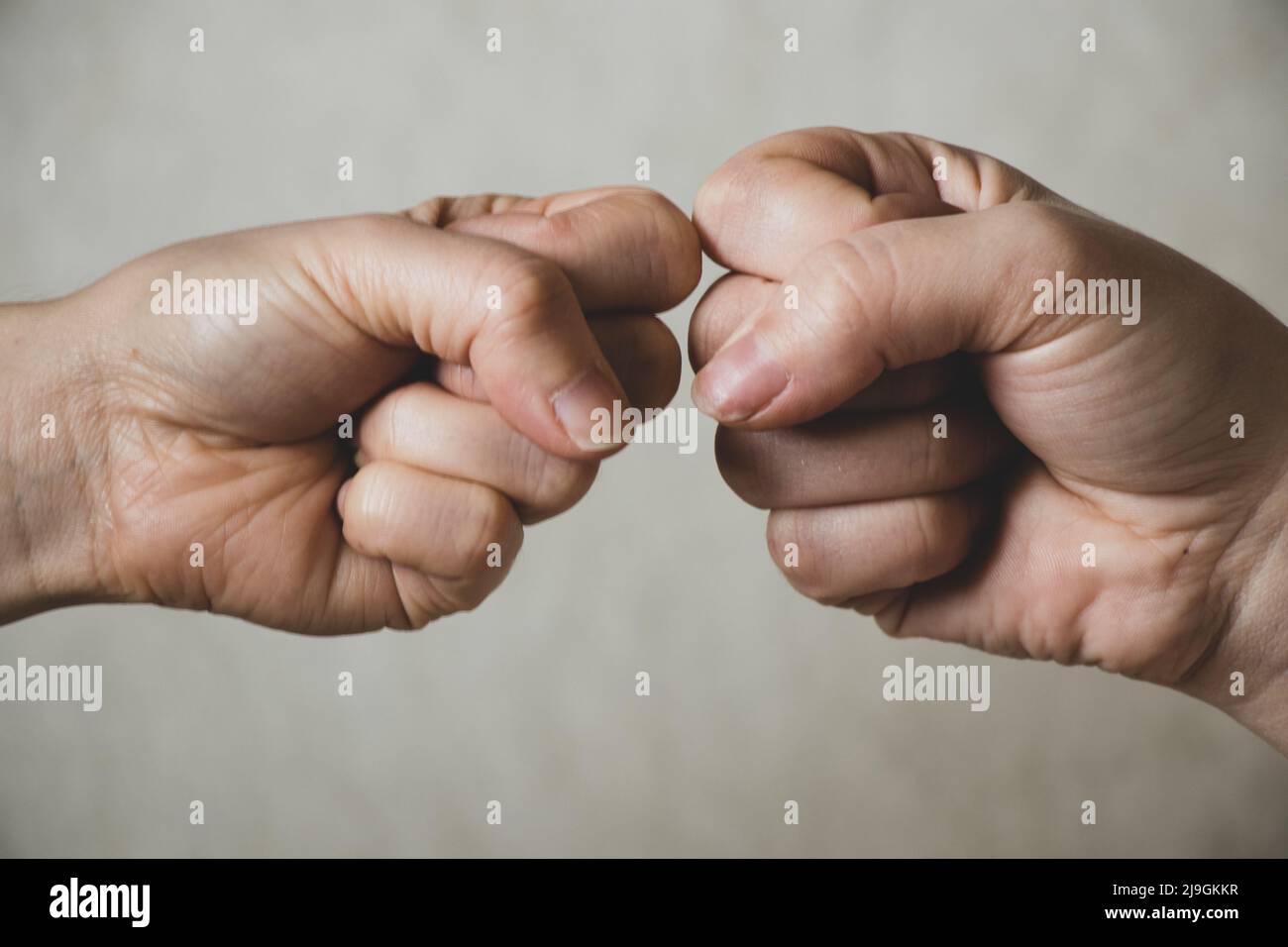 two fists on an isolated background, strength and power, fight and war, stop war, aggression Stock Photo