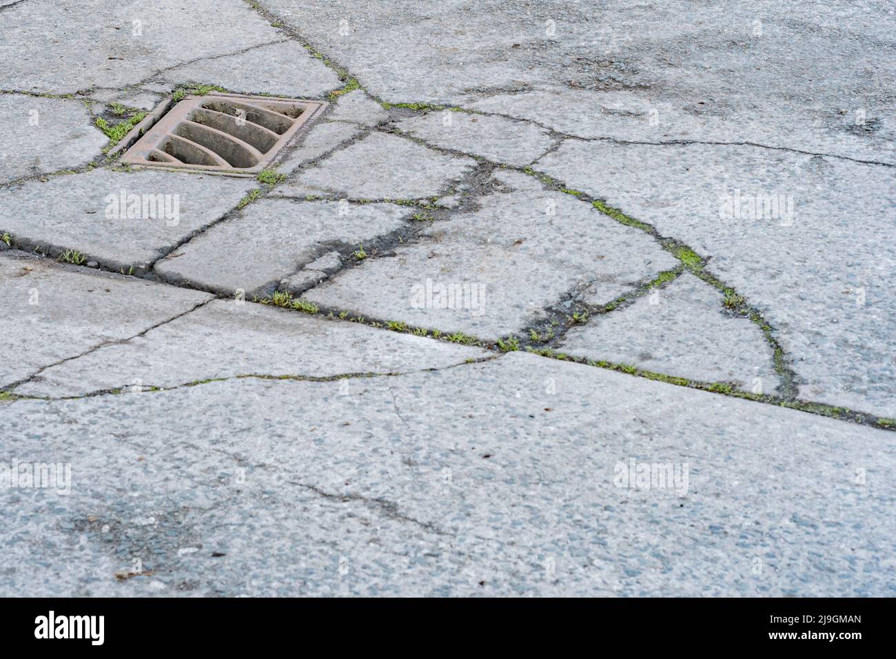 Key drain on section of an industrial yard. Metaphor for 'down the