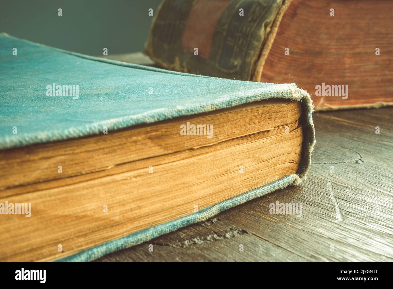 Close-up of old books lying on the table. Stock Photo