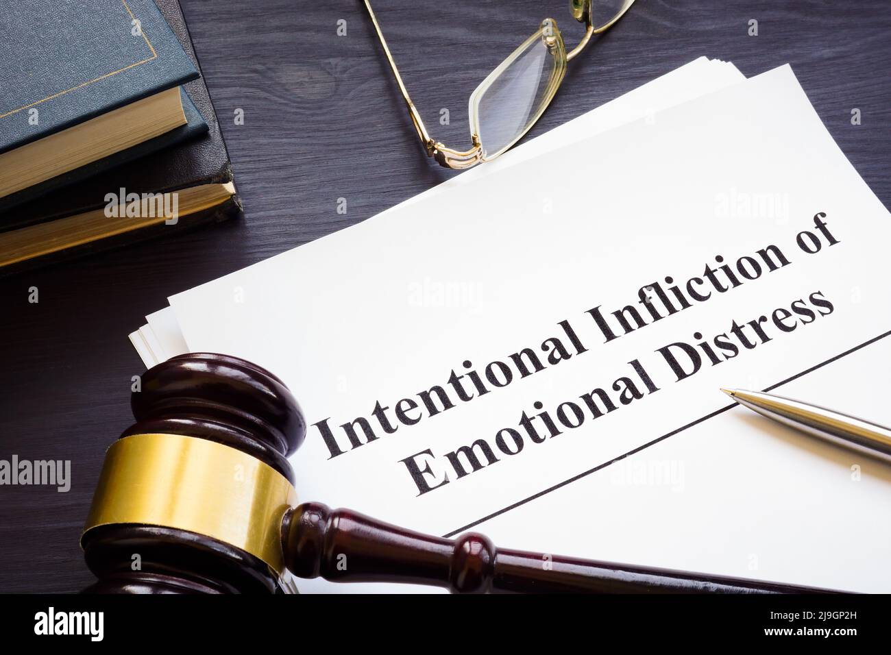 Papers about intentional infliction of emotional distress IIED and gavel. Stock Photo