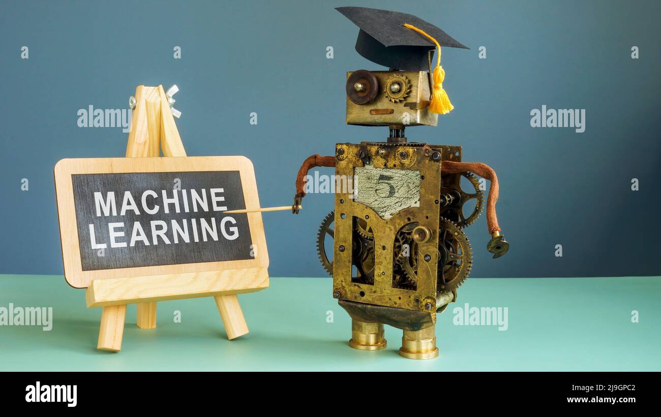 Machine learning concept. The robot is standing next to the chalkboard. Stock Photo