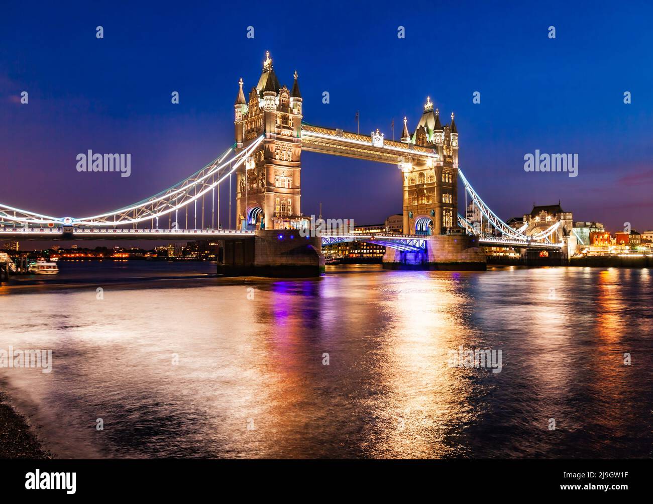 An iconic symbol of London, the Tower Bridge, as viewed from Shad Thames at night Stock Photo