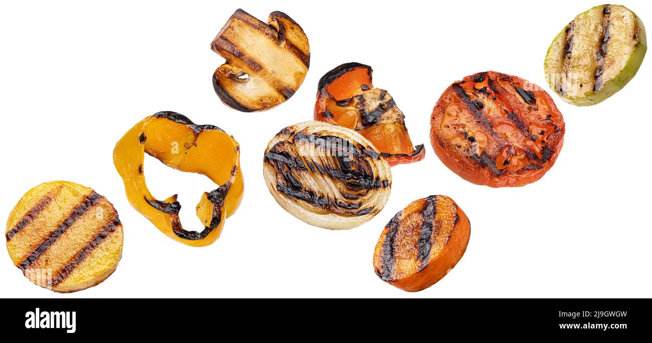 Falling grilled vegetable slices isolated on white background Stock Photo