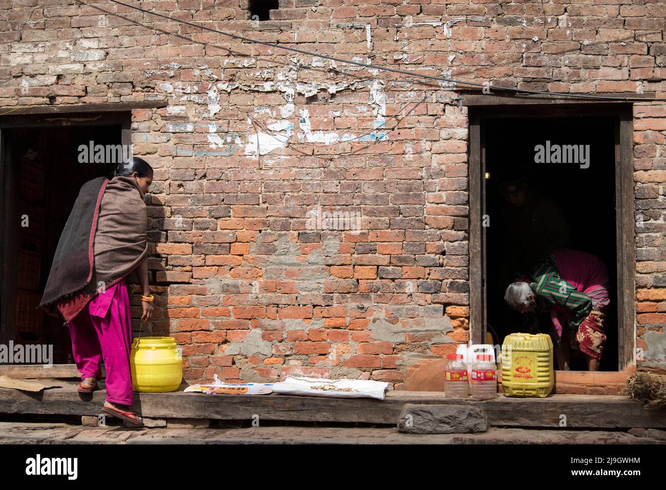 Kathmandu, Nepal- April 20,2022 : Women wash clothes and dishes on the streets of Patan Durbar Square. Stock Photo