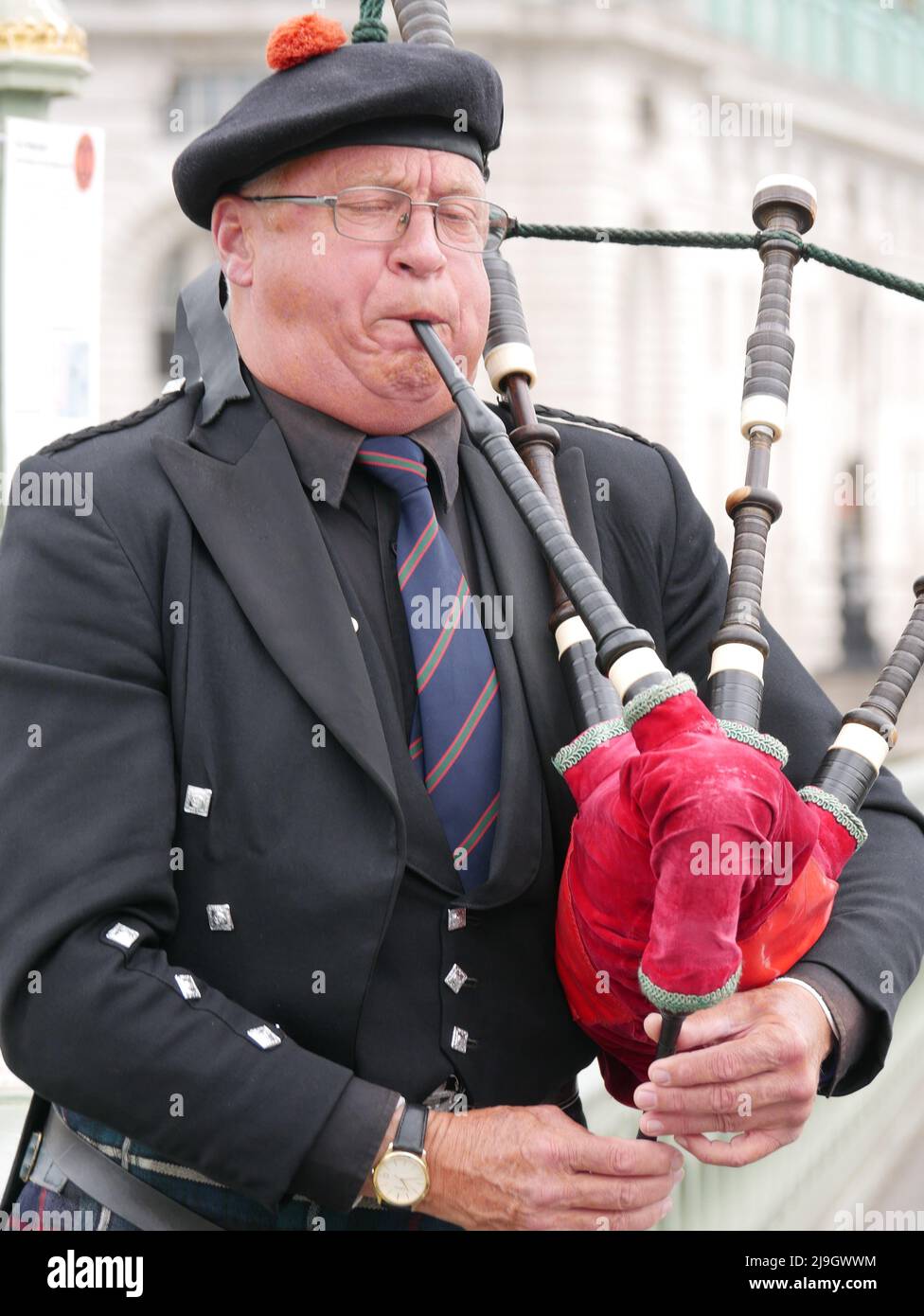 A piper plays traditional bagpipes on Westminster Bridge, London