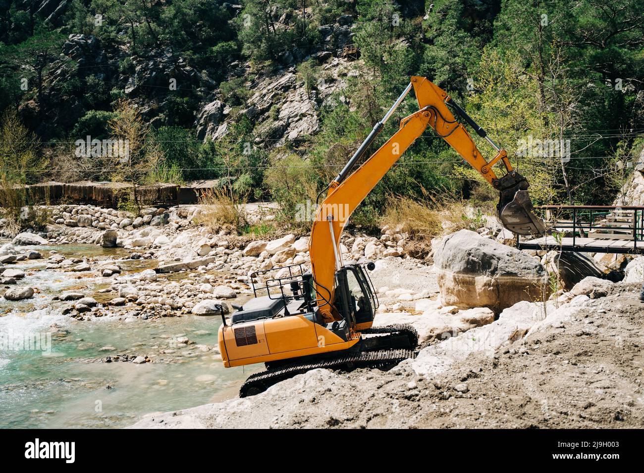 Heavy machinery dragline excavator digging ground in the mountain