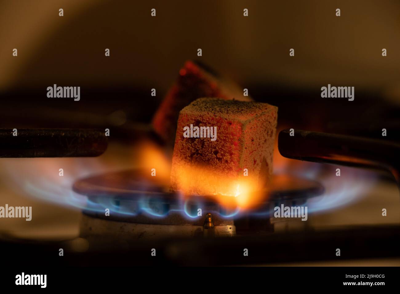 Gas stove in the kitchen with burning coals, burning gas in the kitchen