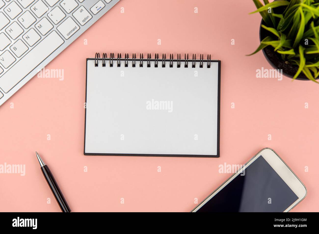 Flat lay office desk with note pad and computer keyboard Stock Photo