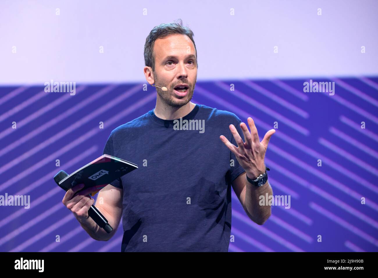 Hamburg, Germany. 18th May, 2022. OMR CEO Philipp Westermeyer moderates on a stage. The OMR digital festival in Hamburg focuses on a combination of trade fair, workshops and party. Credit: Jonas Walzberg/dpa/Alamy Live News Stock Photo