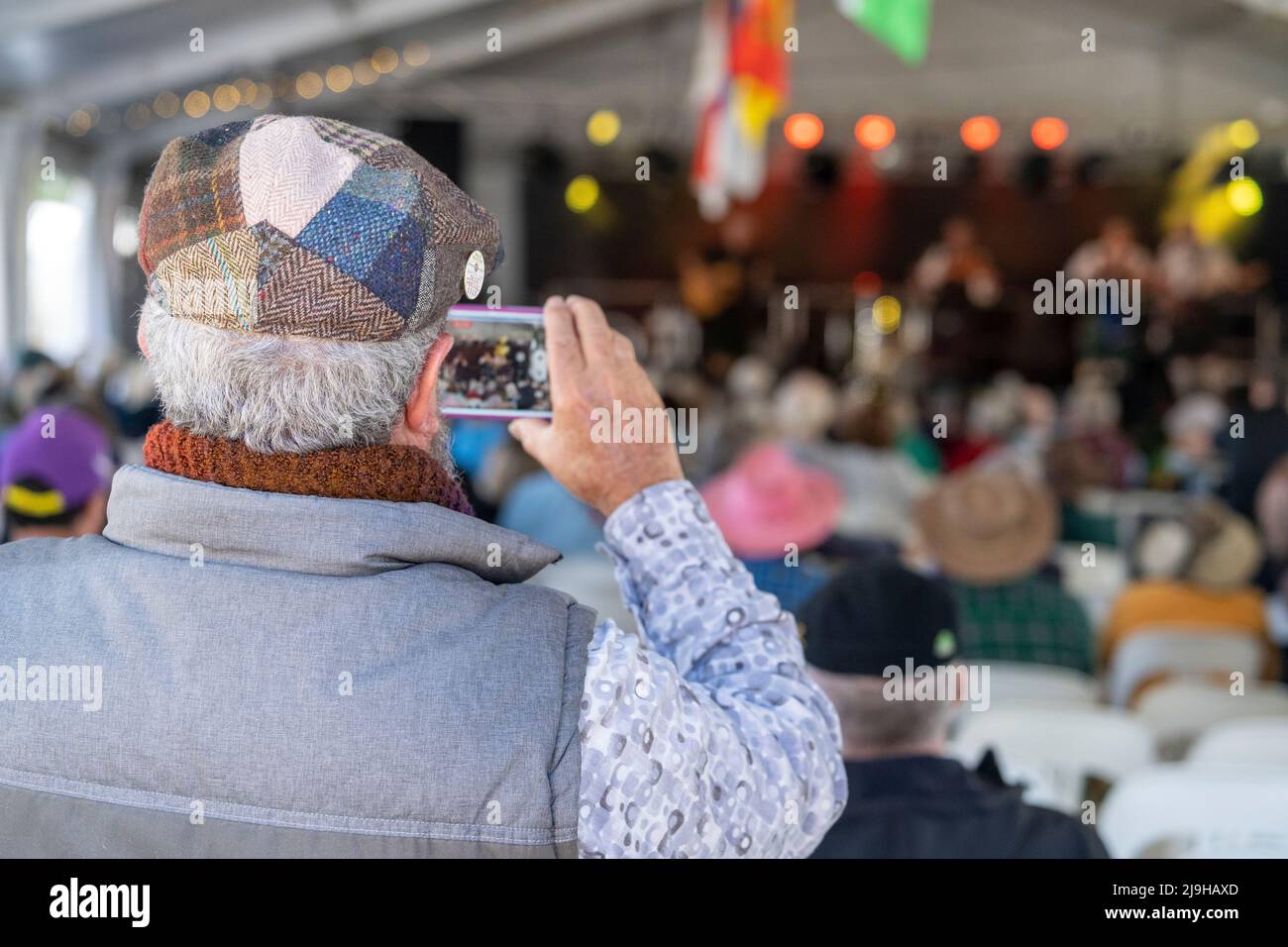 Man using mobile phone to photograph band at Glen Innes Celtic Festival NSW Australia Stock Photo