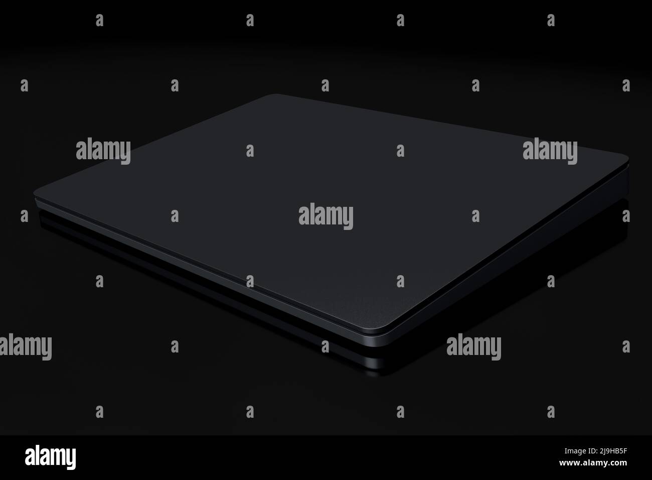 Black computer trackpad or wireless touch pad isolated on black