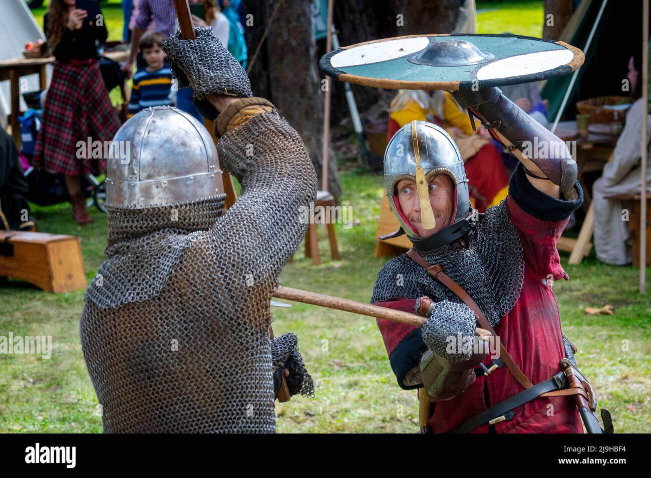 Warriors in chain mail undertake medieval combat at historical re-enactment tournament. Glen Innes Celtic Festival, New South Wales Australia Stock Photo