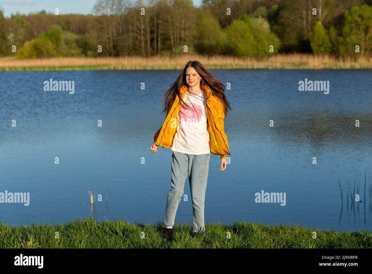 Portrait of stylish weared teenage girl outdoors in spring. A girl ...
