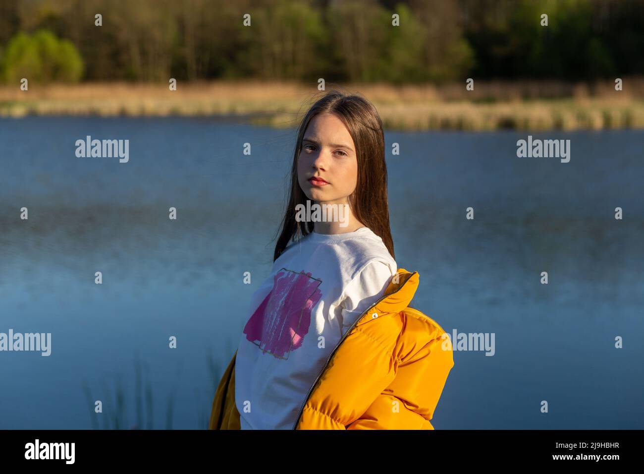 Portrait of stylish weared teenage girl outdoors in spring. A girl ...