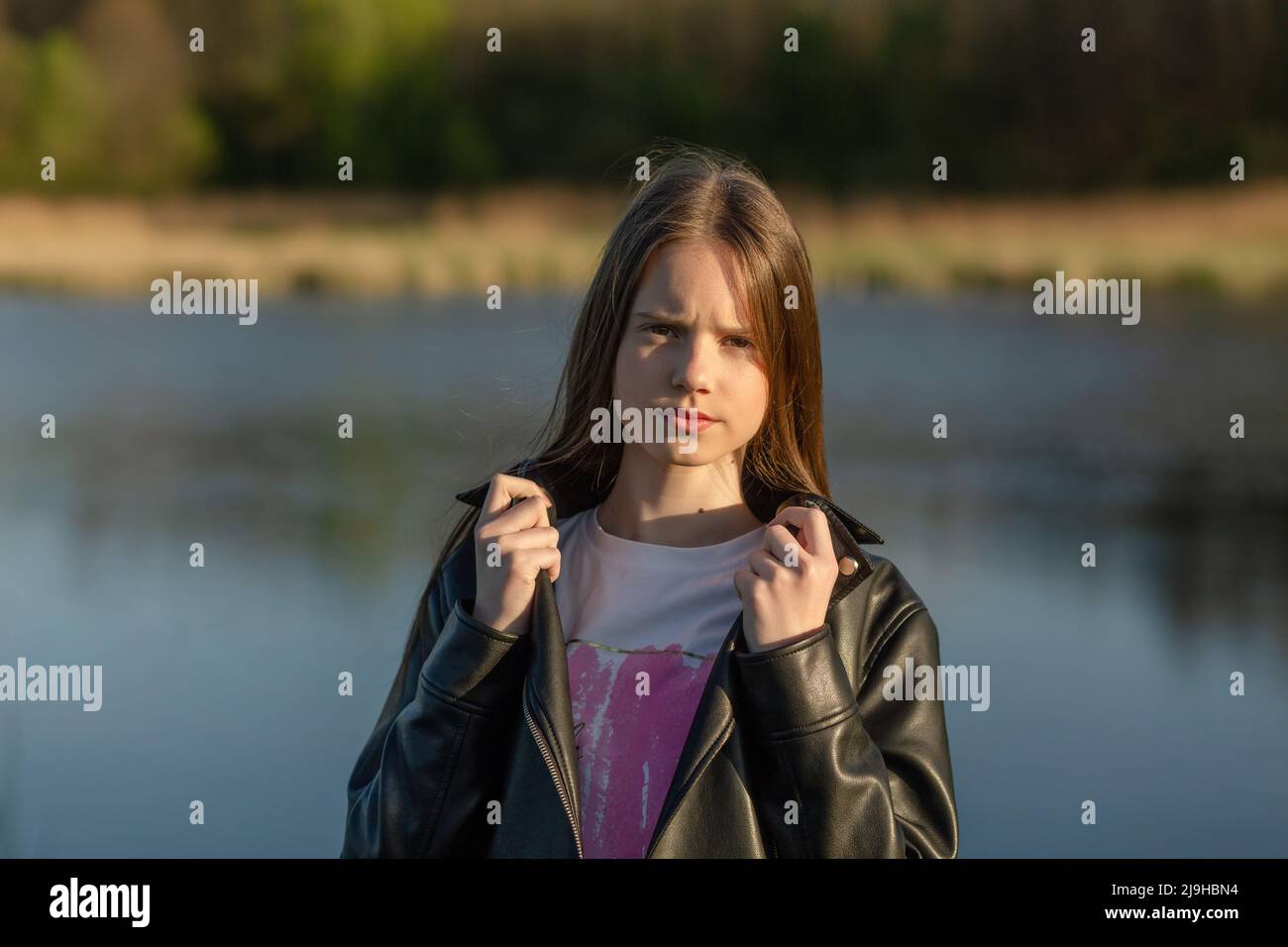 Portrait of a beautiful happy teenage girl outdoors in spring. A girl ...