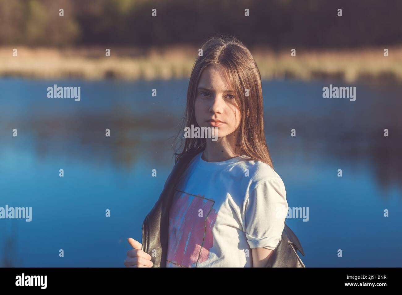 Portrait of a beautiful happy teenage girl outdoors in spring. A girl