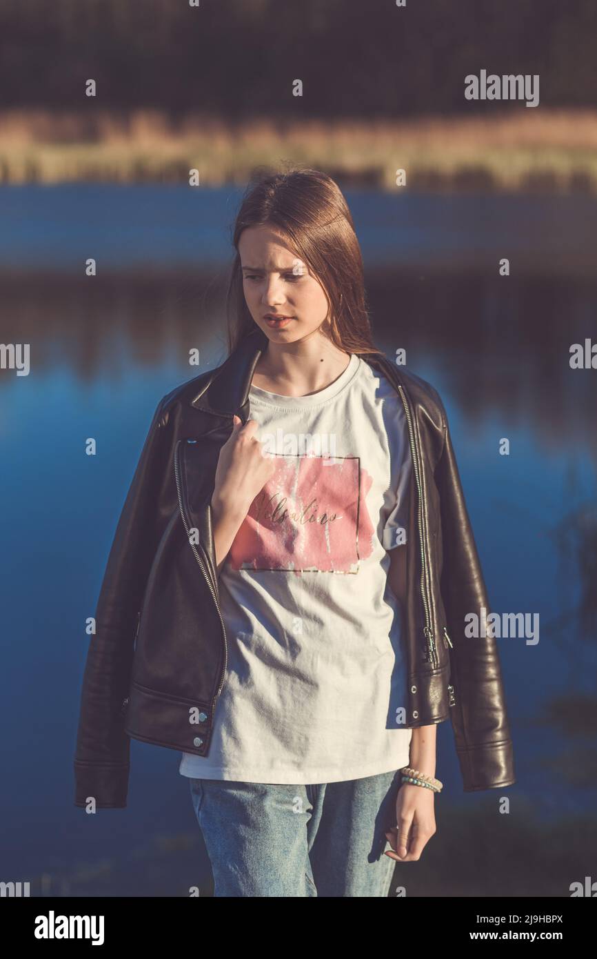 Portrait of a beautiful happy teenage girl outdoors in spring. A girl ...