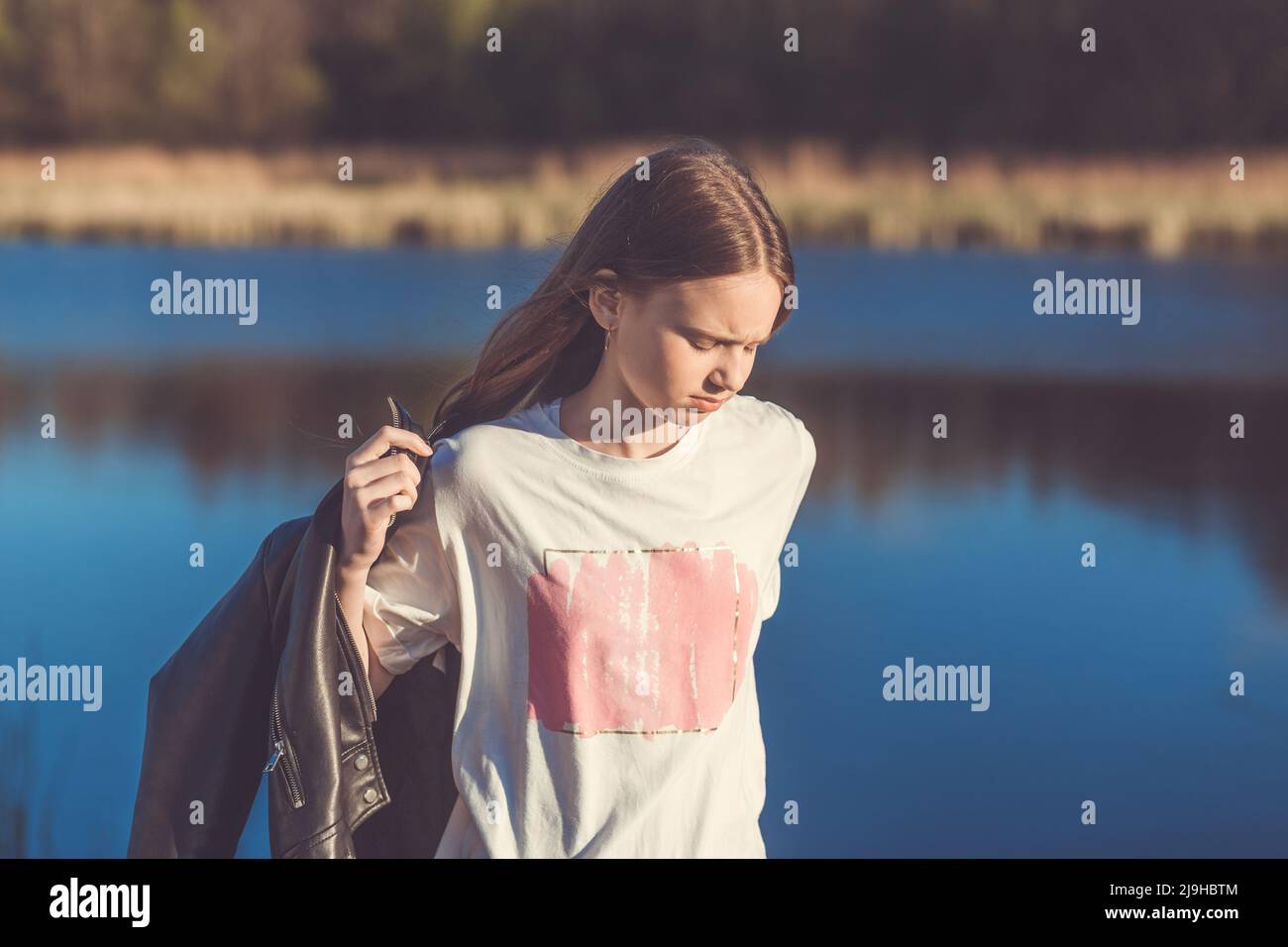 Portrait of a beautiful happy teenage girl outdoors in spring. A girl ...