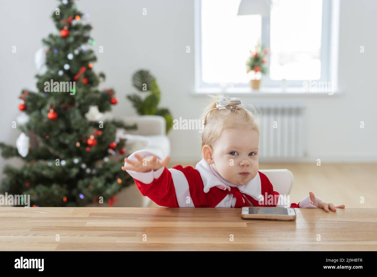 Child girl dressed in christmas dress with cochlear implants having fun at  home - diversity and hearing aid and innovating technologies for treatment  Stock Photo - Alamy