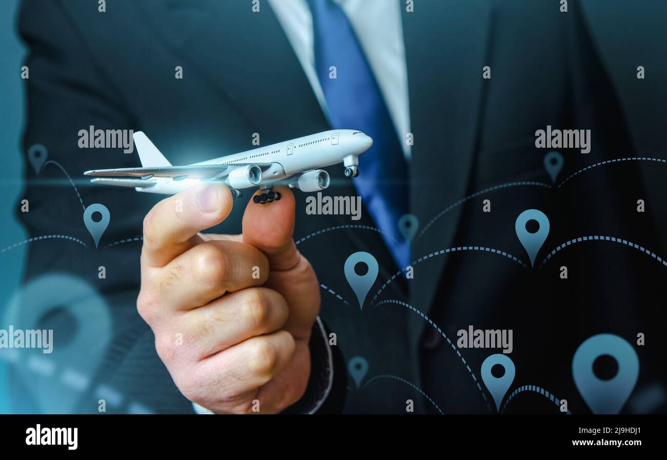 A plane taking off in the hands of a businessman and a pin location symbol. Business tourism. Organization of air traffic. Business class flights. Sup Stock Photo