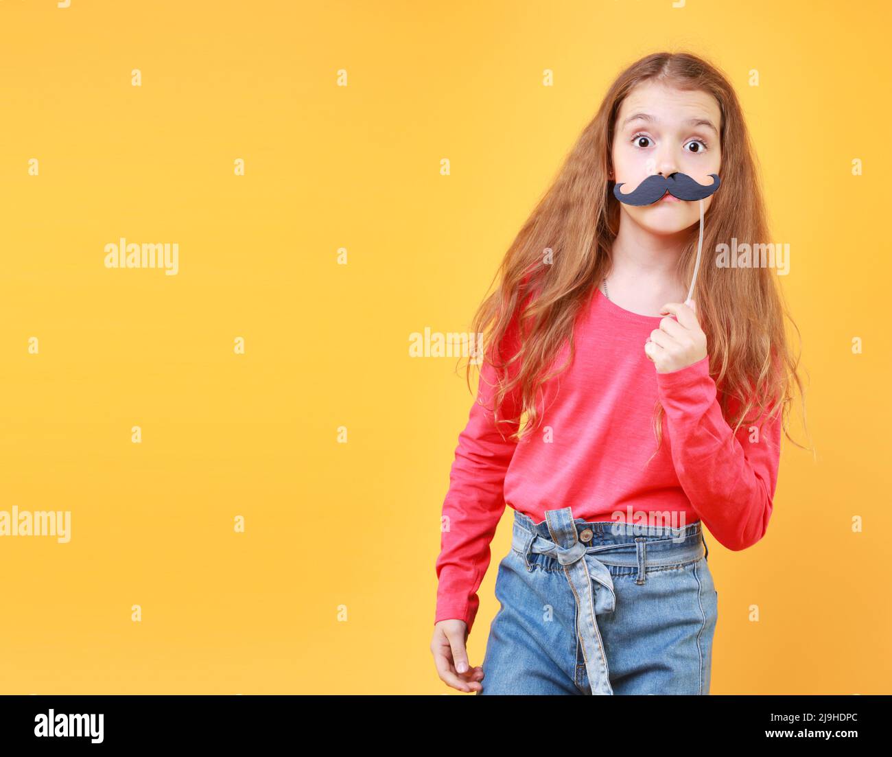Funny mustache face child girl have a fun on yellow empty space