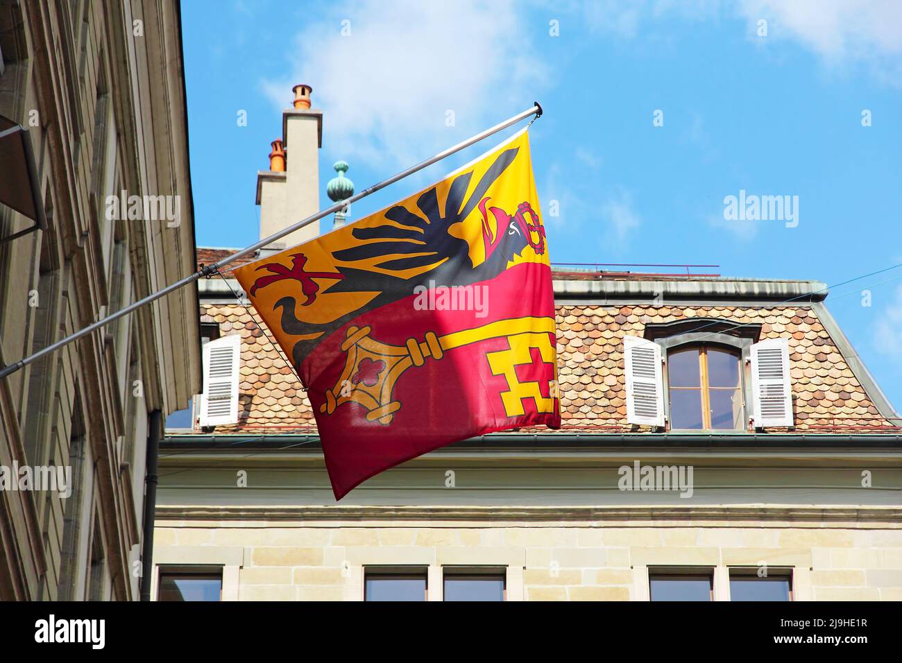 Flag of the Canton of Geneva, Switzerland on the front of the building. Stock Photo