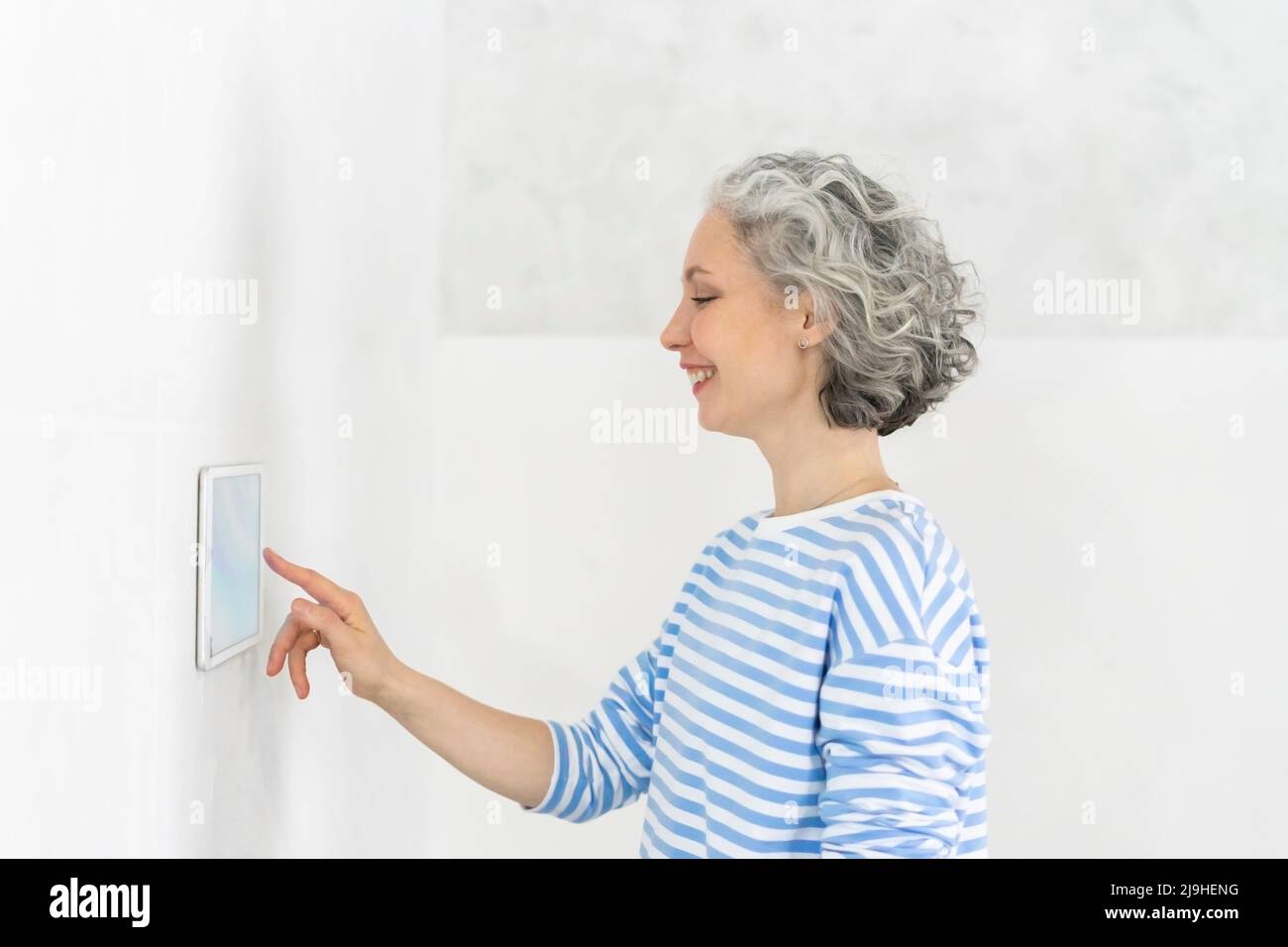 Happy woman touching tablet pc hi-res stock photography and images - Alamy