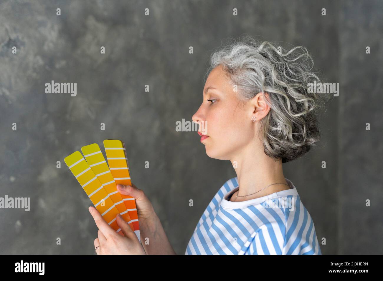 Woman with color swatch at new home Stock Photo