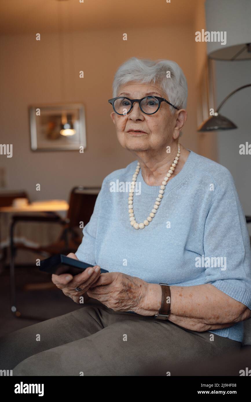 Senior woman remote control hi-res stock photography and images - Alamy