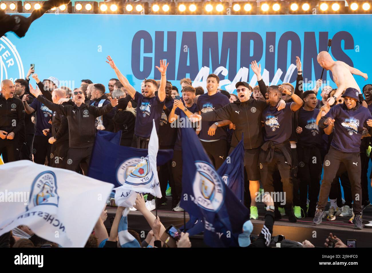 Manchester, UK. 23rd May, 2022. Manchester City celebrate winning their forth Premier League title in five years with a parade through the city. Thousands of fans lined the streets to welcome Guardiola and the squad as they travelled through the city showing off the latest trophy. Credit: Andy Barton/Alamy Live News Stock Photo