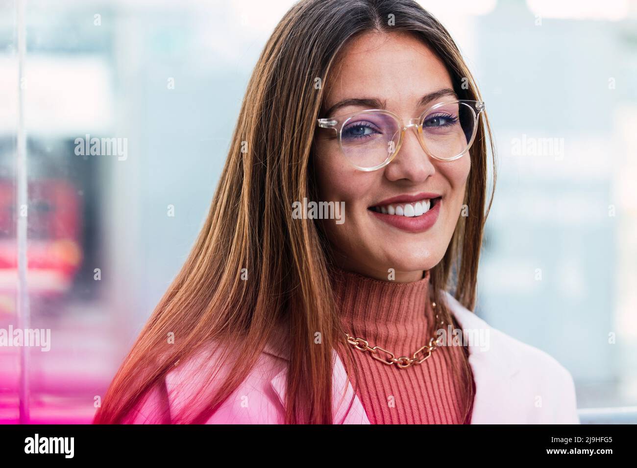 Smiling young woman wearing eyeglasses Stock Photo