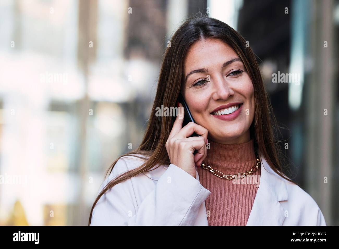 Happy woman talking on mobile phone Stock Photo