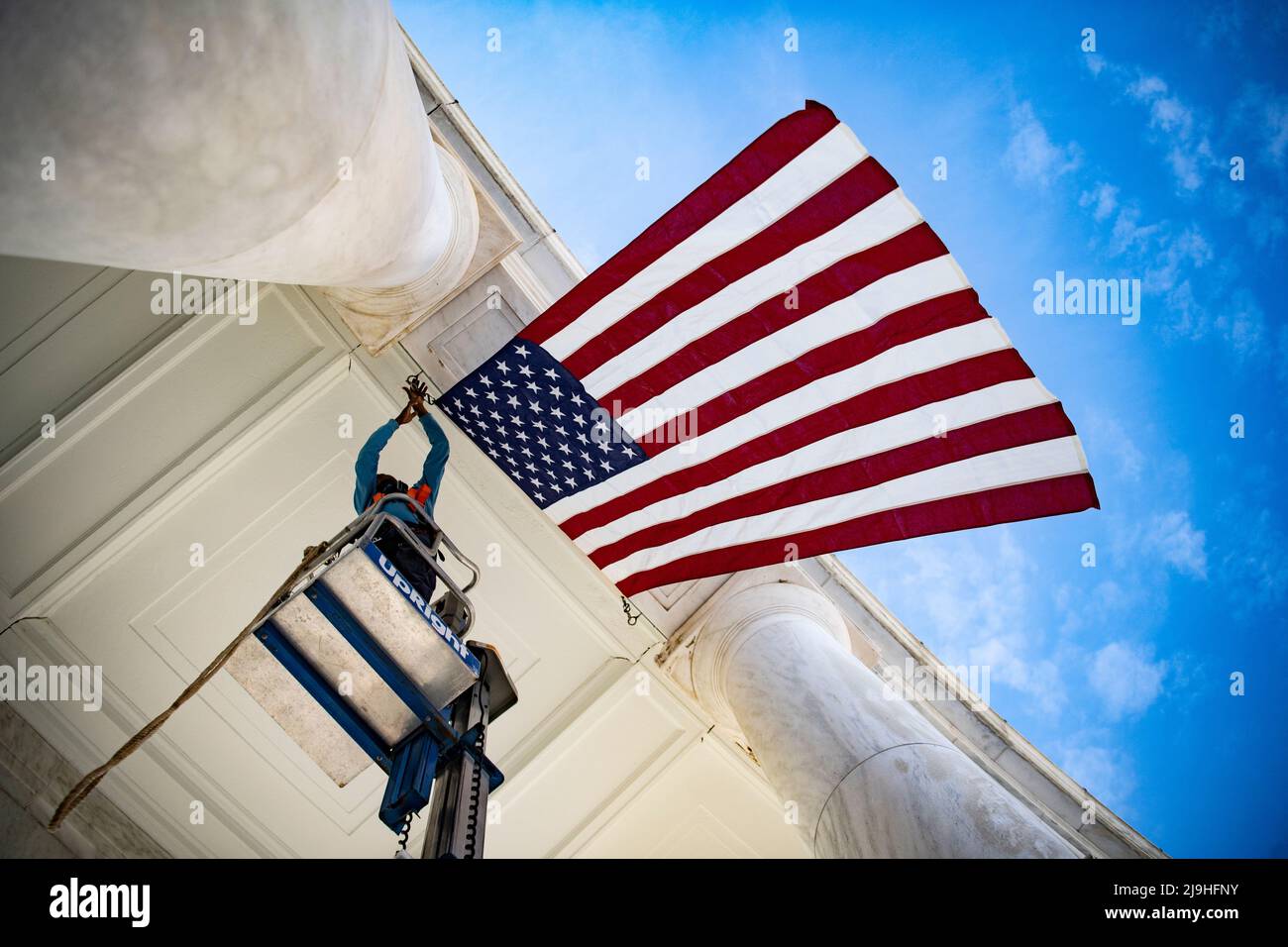 Arlington, United States Of America. 23rd May, 2022. Arlington, United States of America. 23 May, 2022. Facilities maintenance employees hang American flags in the Arlington National Cemetery Memorial Amphitheater in preparation for the annual Memorial Day event honoring the nations war dead, May 23, 2022 in Arlington, Virginia, USA. Credit: Elizabeth Fraser/U.S. Army/Alamy Live News Stock Photo