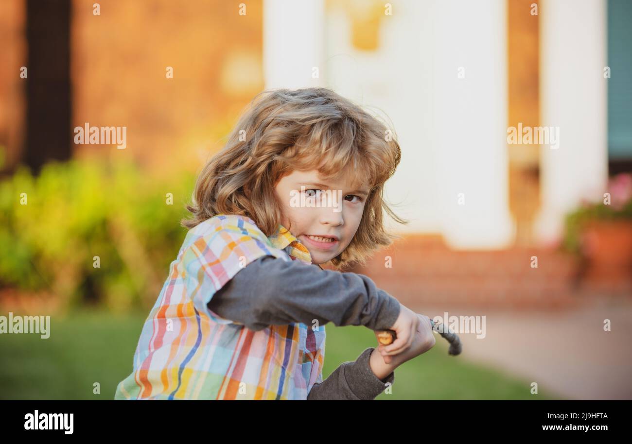 Negative child emotion. Kids aggression. Angry boy with stick. Kid