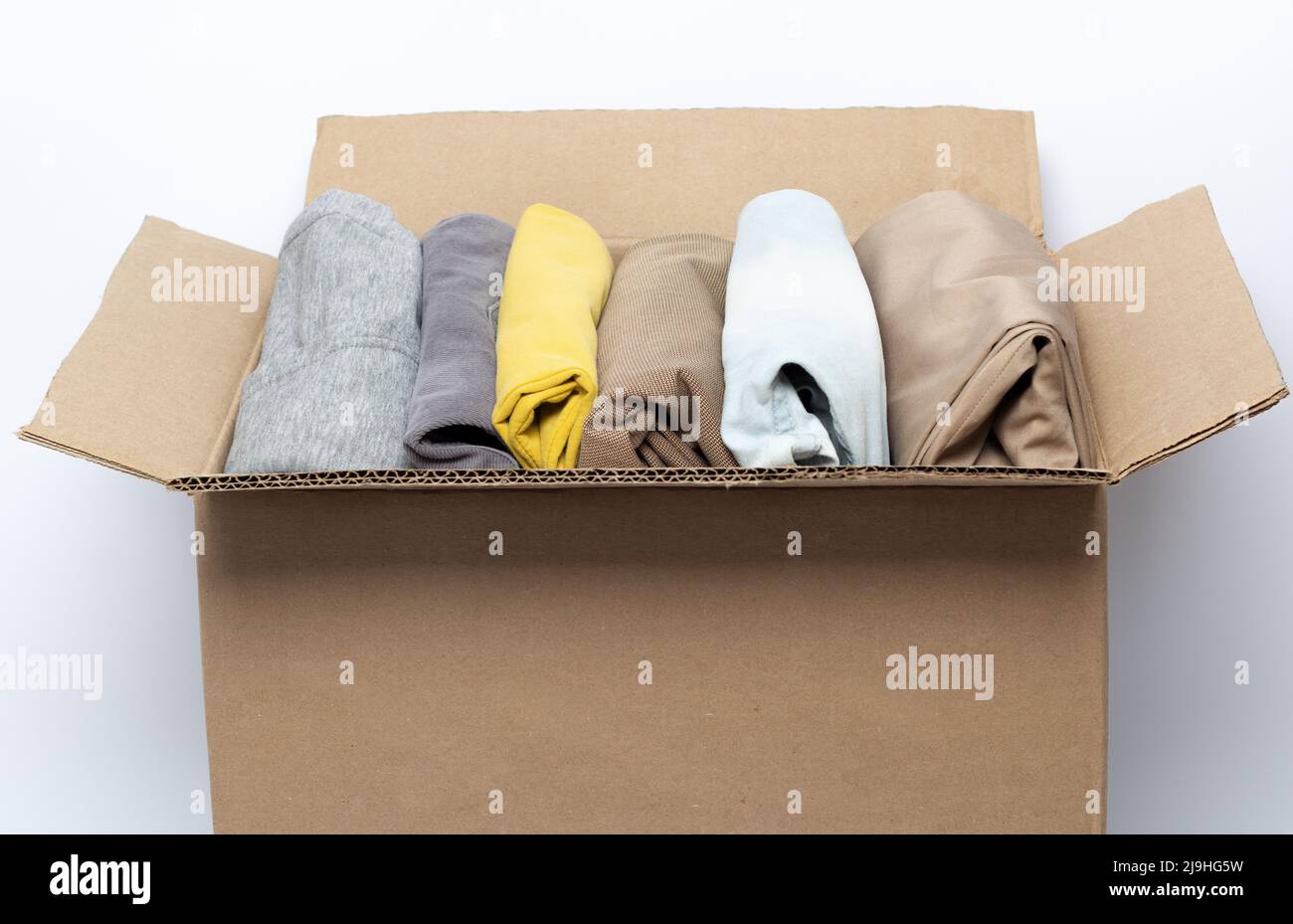 Donation clothes box on a white background. Charity concept. Waste recycling. Stock Photo