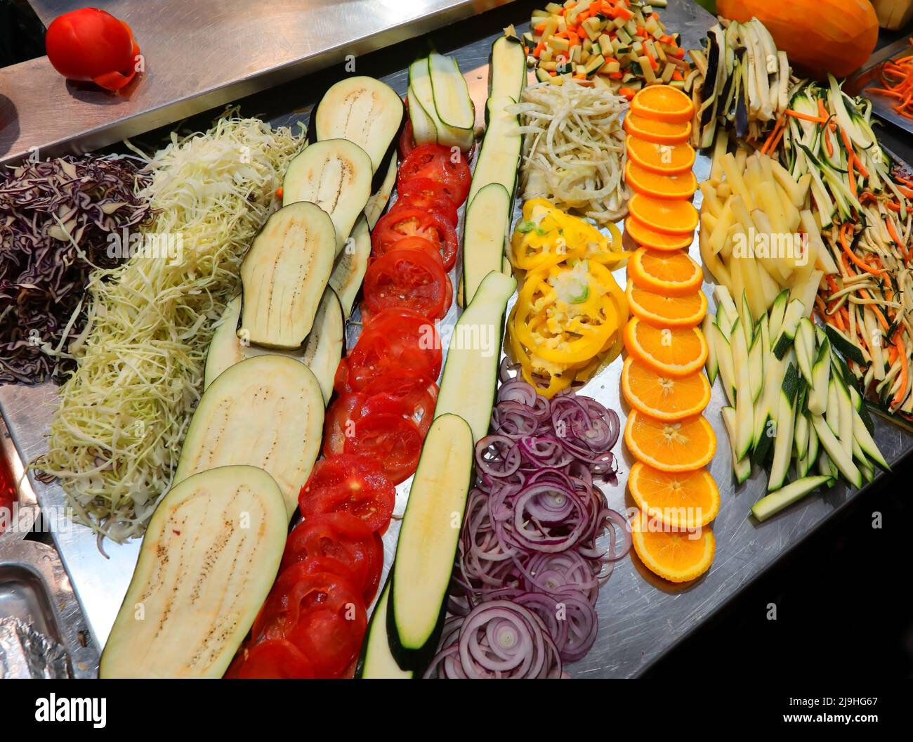 steel table with a lot of vegetables cut to the preparation of food in the restaurant of the industrial canteen Stock Photo