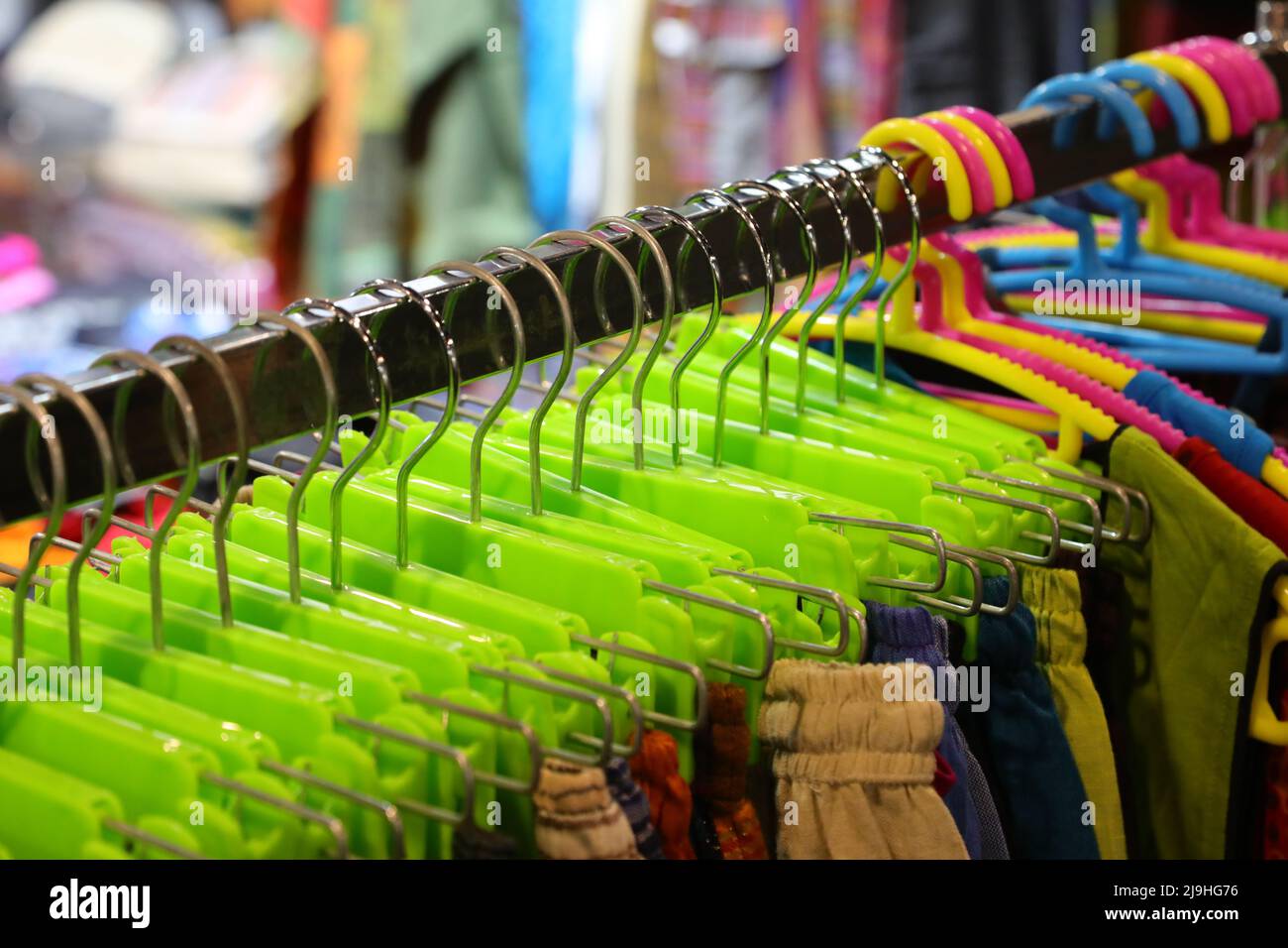 many coat hangers with clothes hanging on sale in the childrens