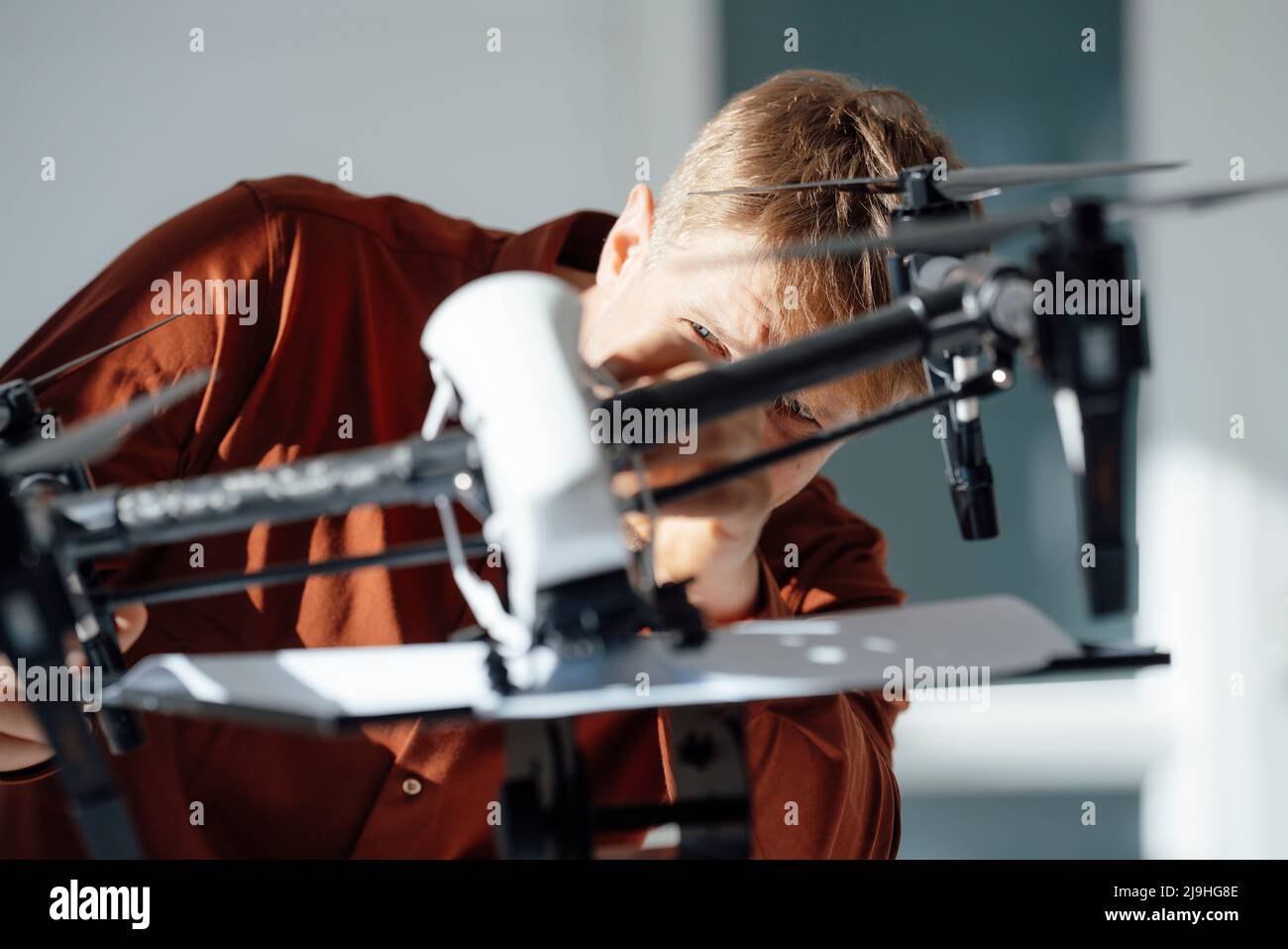 Engineer analyzing drone in office Stock Photo - Alamy
