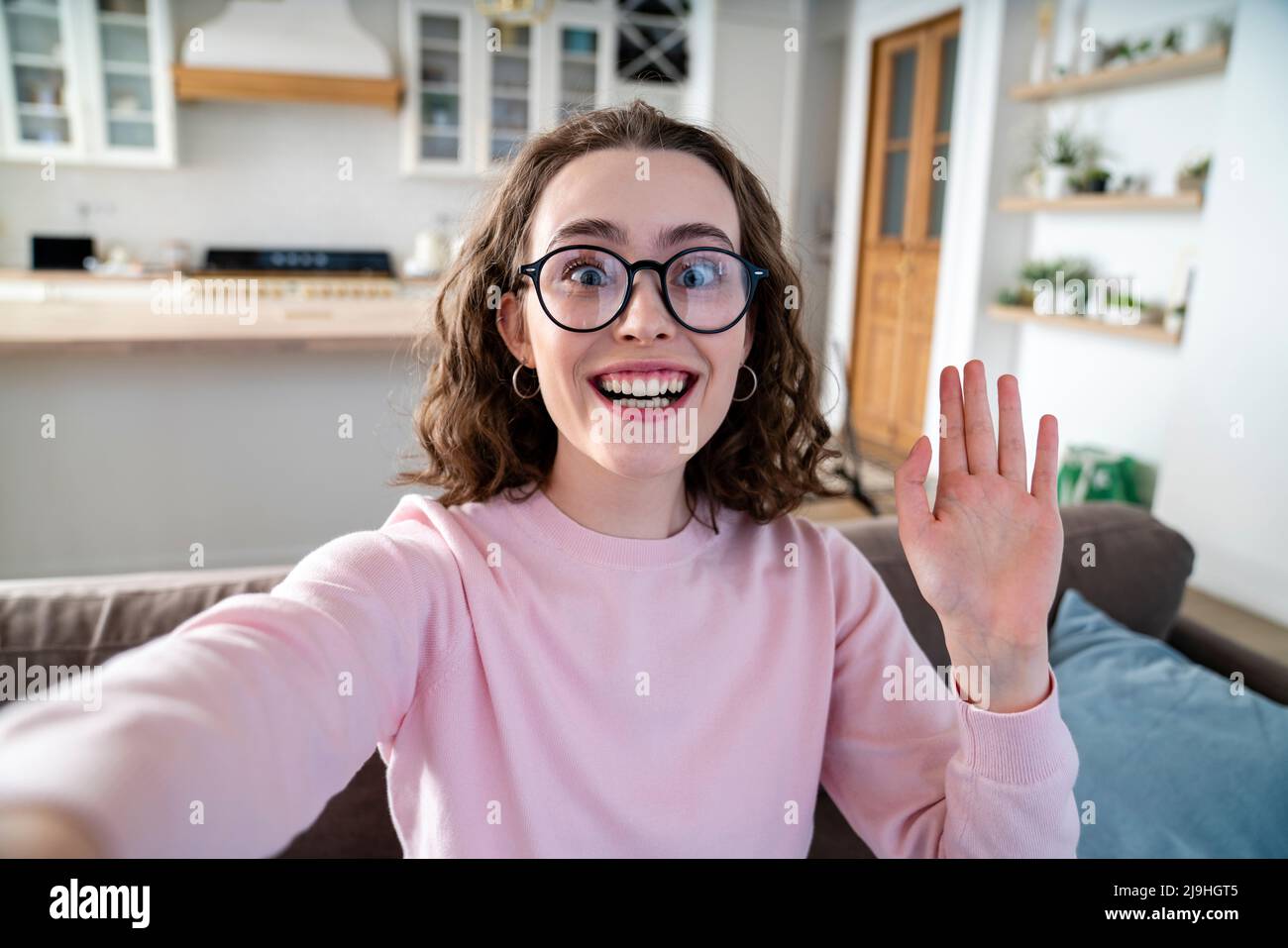 Happy woman taking selfie at home Stock Photo - Alamy