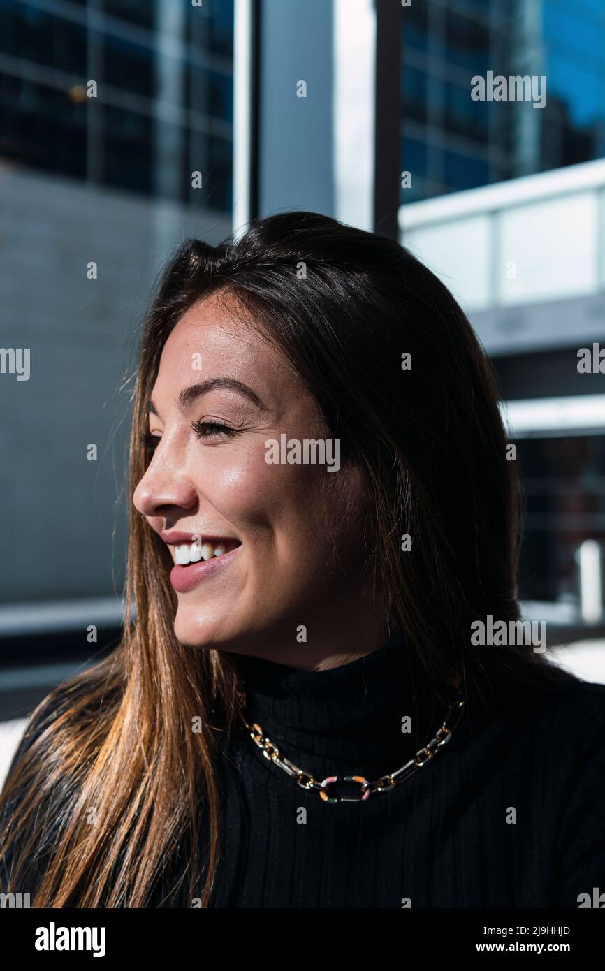 Happy young woman with long brown hair Stock Photo